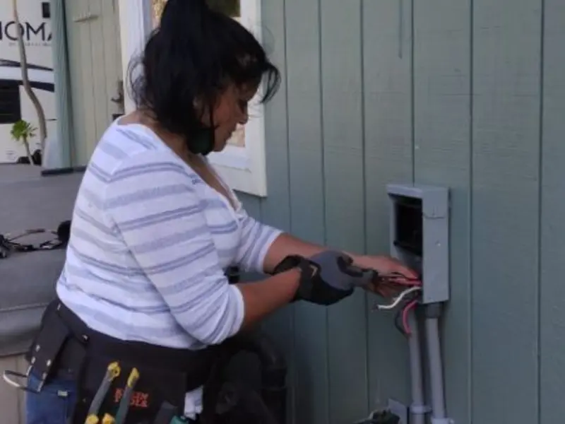 Licensed electrician wiring an exterior subpanel in Paris